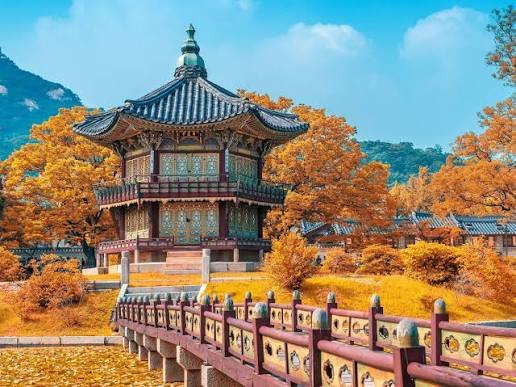 A traditional Korean pavilion and bridge in Seoul in autumn.